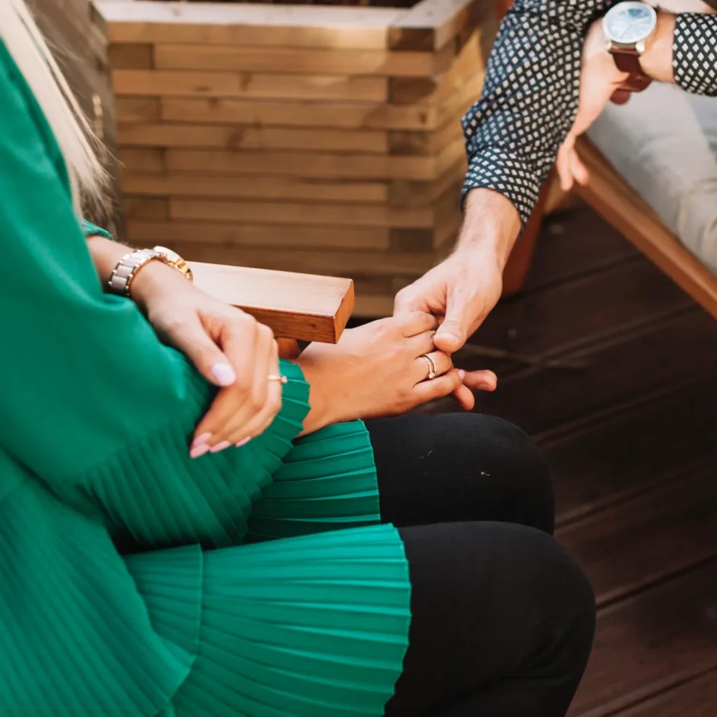 Supportive therapeutic approach in Barcelona — close-up of hands showing empathy and trust in therapy session.